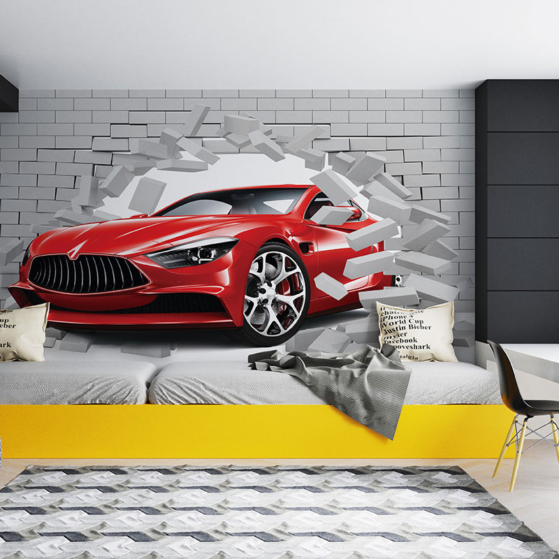 Foto tapeta Crveni automobil kroz sivu ciglu na zidu